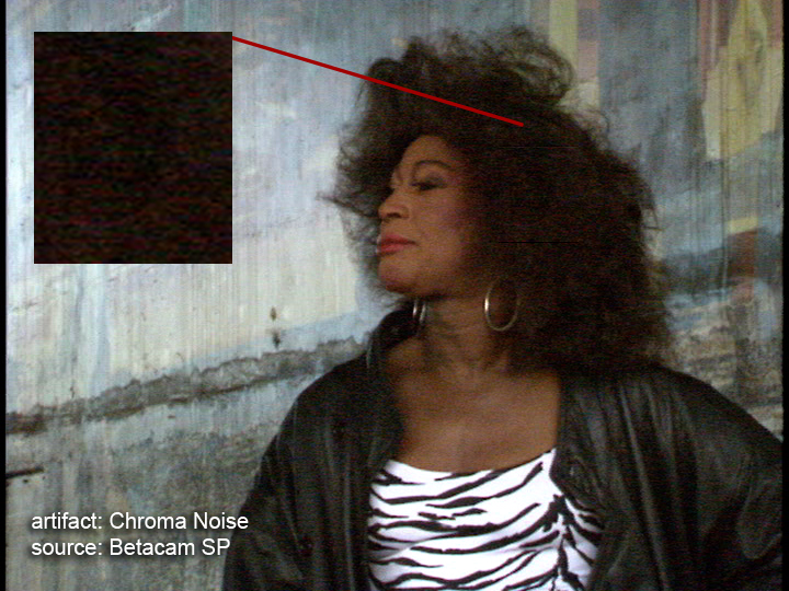 An illustration of chrominance noise in a Betacam transfer (red specks in a woman's dark hair)